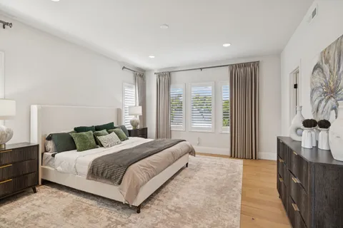 a spacious bathroom with a granite countertop sink a mirror and a potted plant