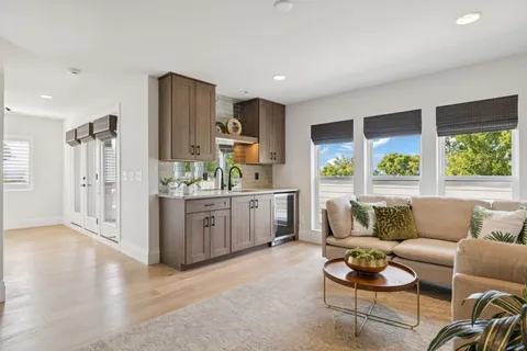 a view of a backyard with potted plants and wooden fence
