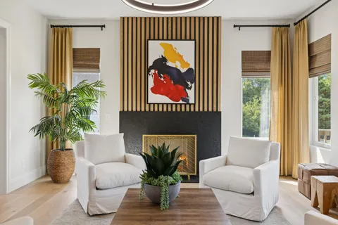 a living room with furniture kitchen and a table