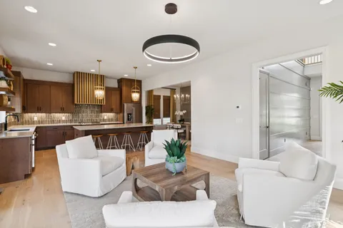 a kitchen with a dining table chairs sink and cabinets
