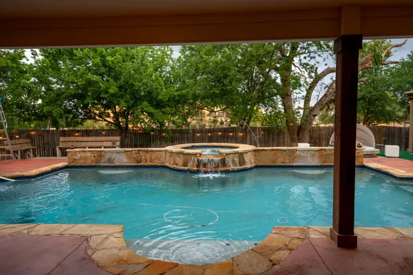 a view of a swimming pool with a patio
