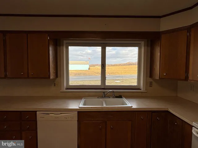a kitchen with a sink and a window