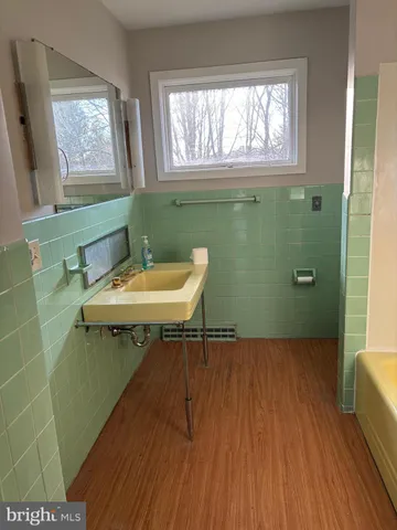 a bathroom with a sink a toilet and a window