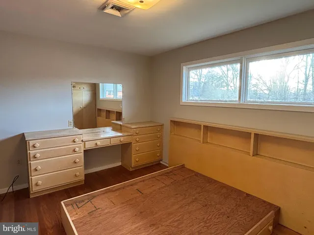 a room with a bed and a cabinets