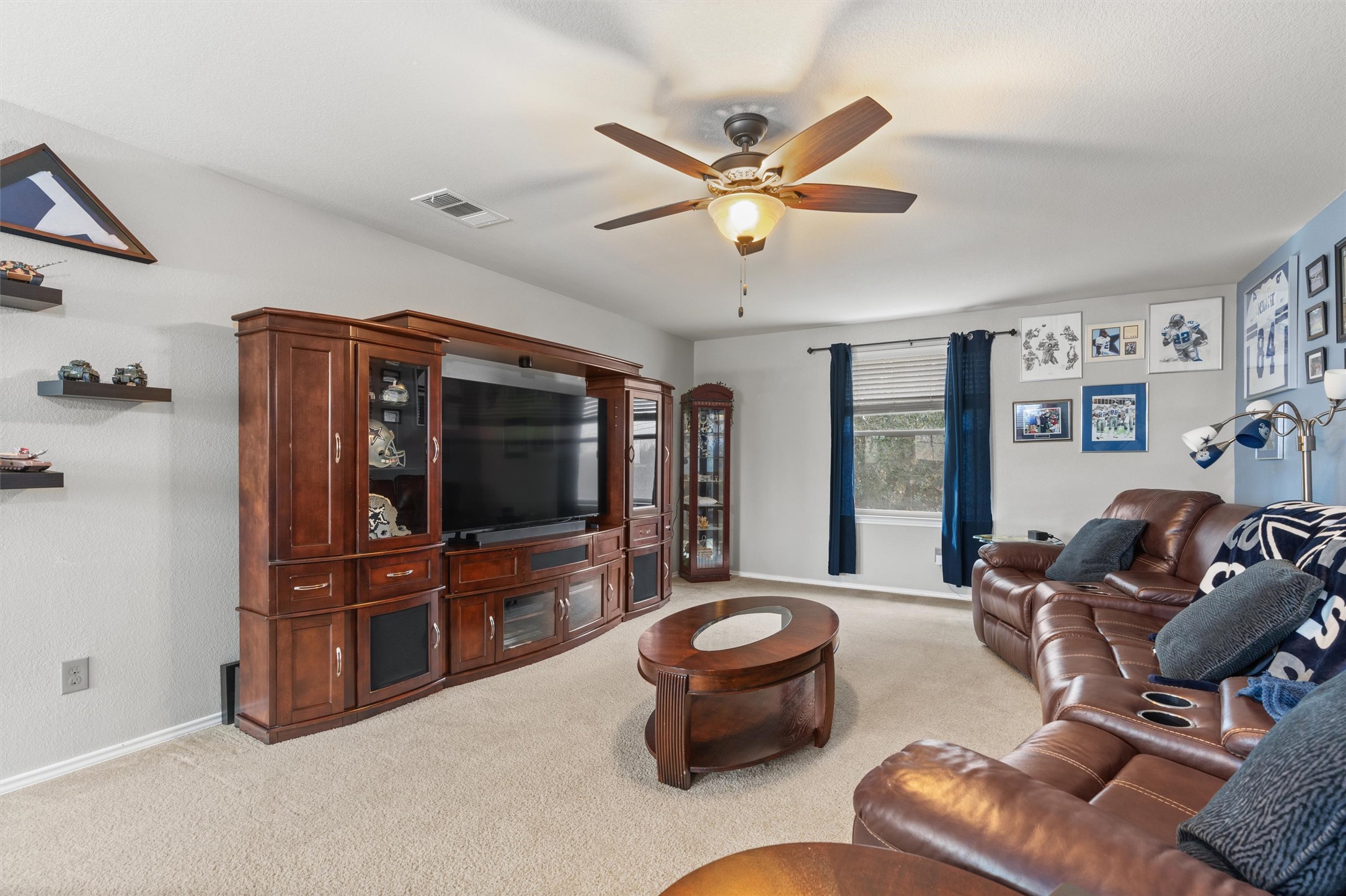 338 Altamont Street Hutto, TX 78634 - Photo 19 of 40 Living area with light colored carpet and ceiling fan