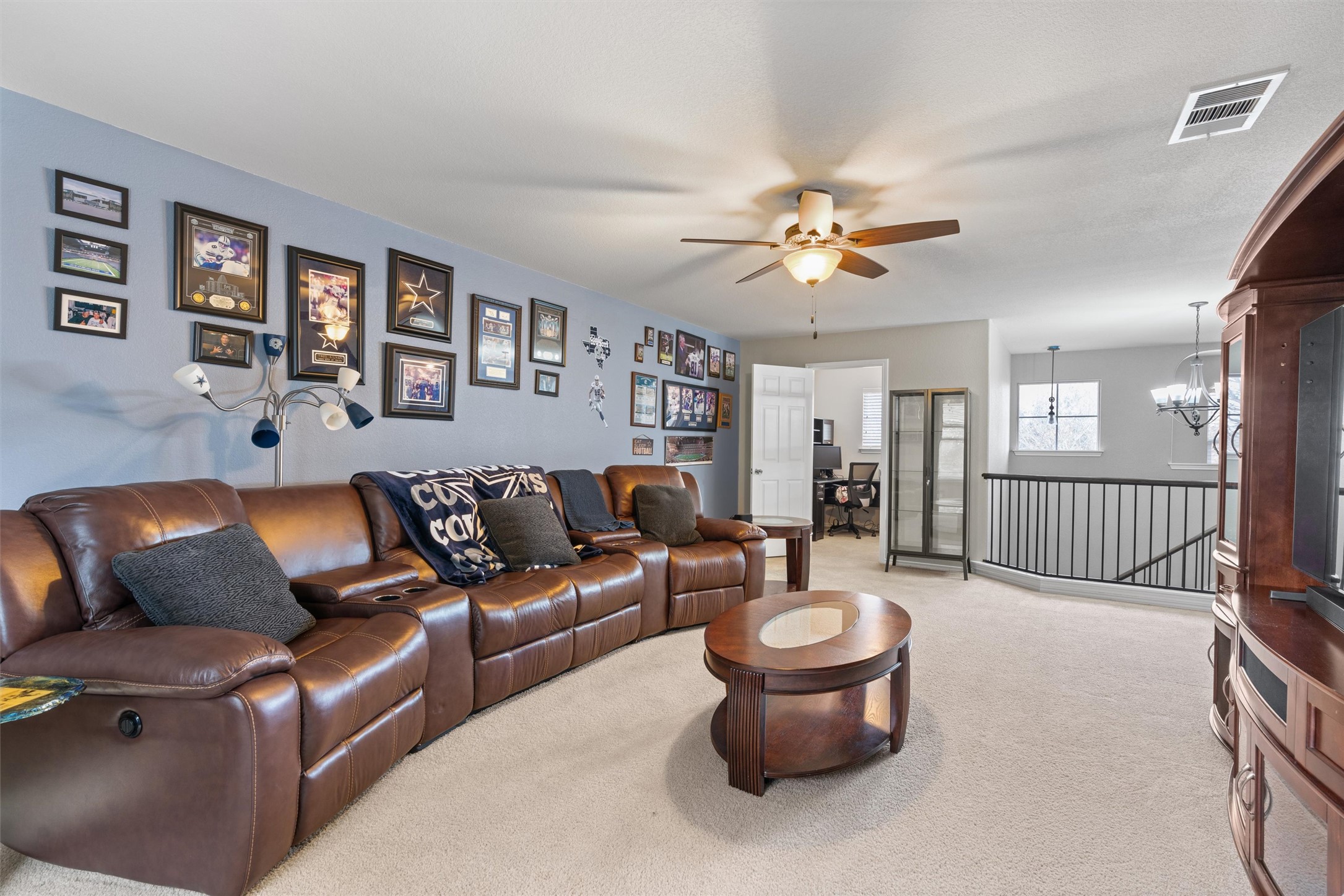 338 Altamont Street Hutto, TX 78634 - Photo 20 of 40 Living area with suspended lighting, light colored carpet, and ceiling fan