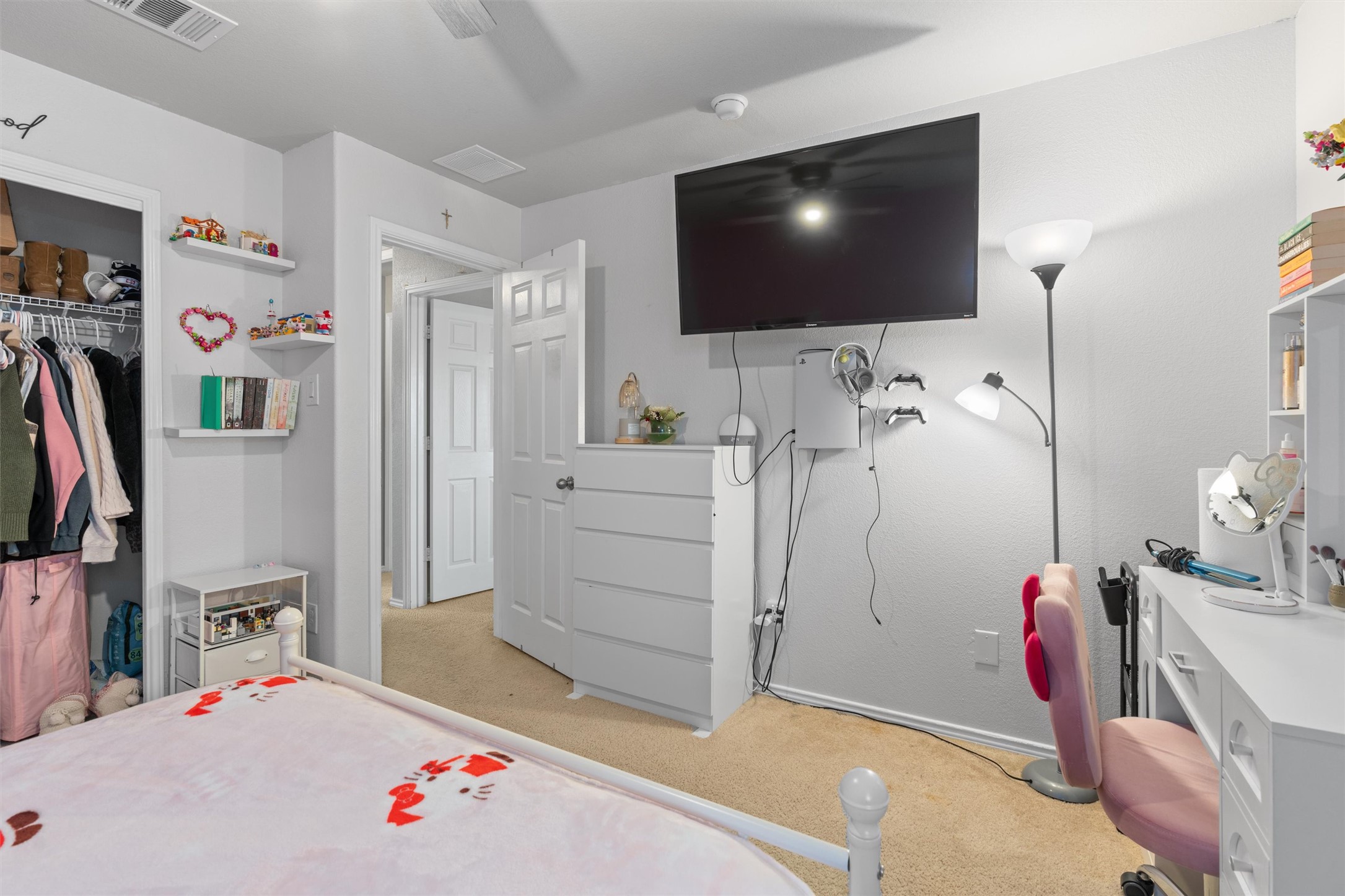 338 Altamont Street Hutto, TX 78634 - Photo 27 of 40 Bedroom featuring light carpet, a closet, and a ceiling fan