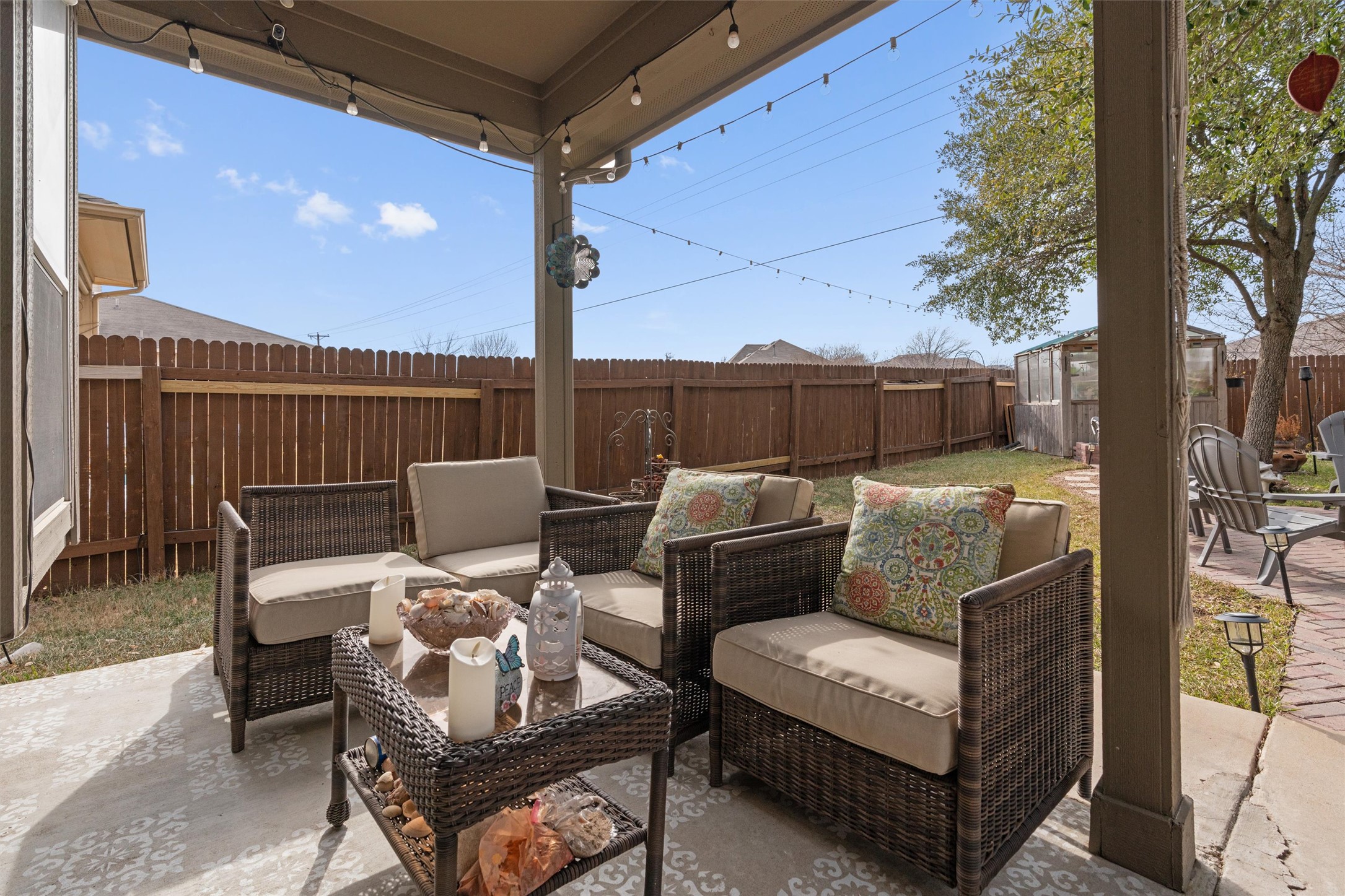 338 Altamont Street Hutto, TX 78634 - Photo 28 of 40 Fenced backyard featuring a patio, an outdoor hangout area, and a storage shed