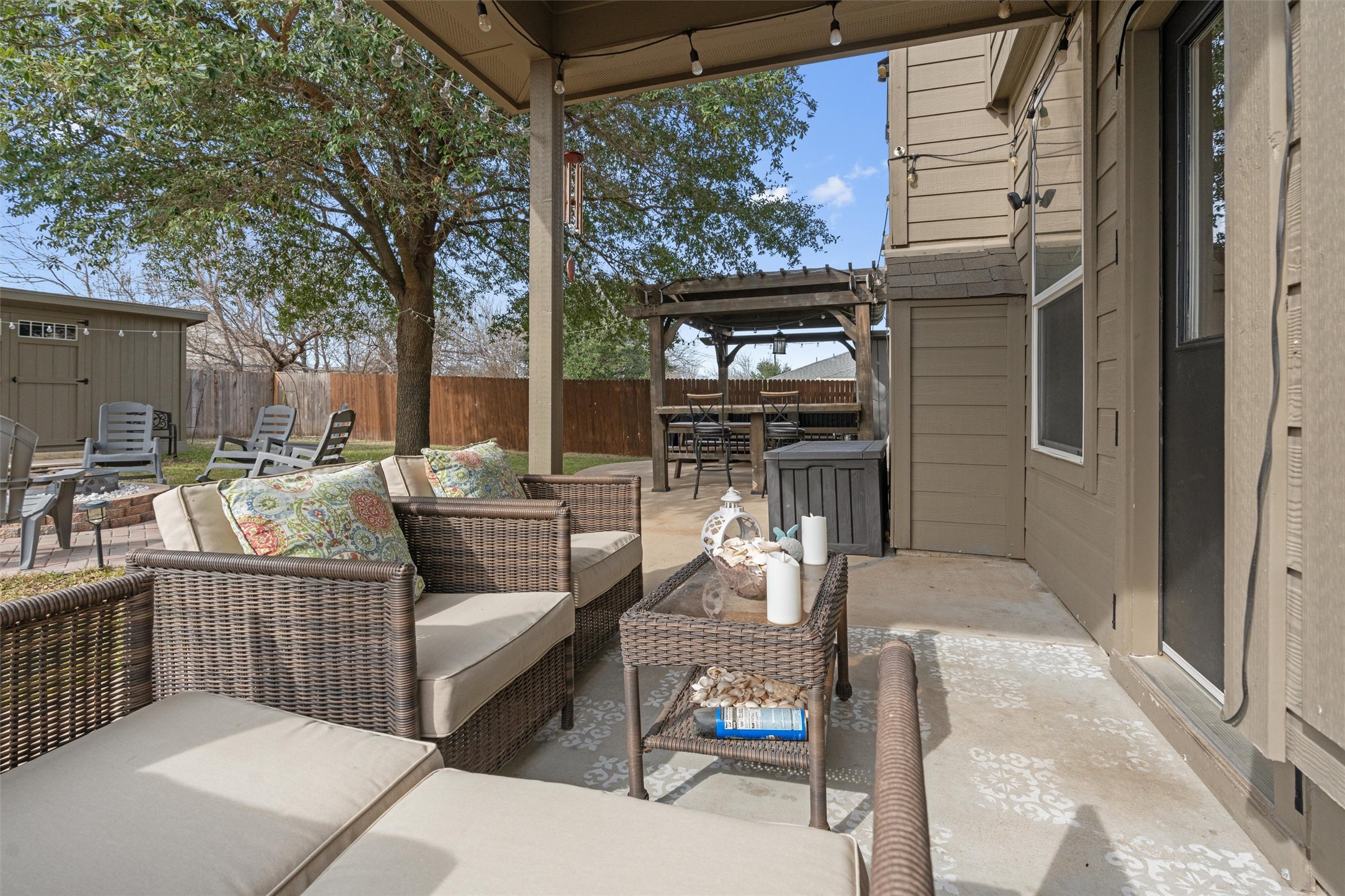 338 Altamont Street Hutto, TX 78634 - Photo 29 of 40 Fenced backyard featuring outdoor lounge area, a patio, a pergola, and an outbuilding
