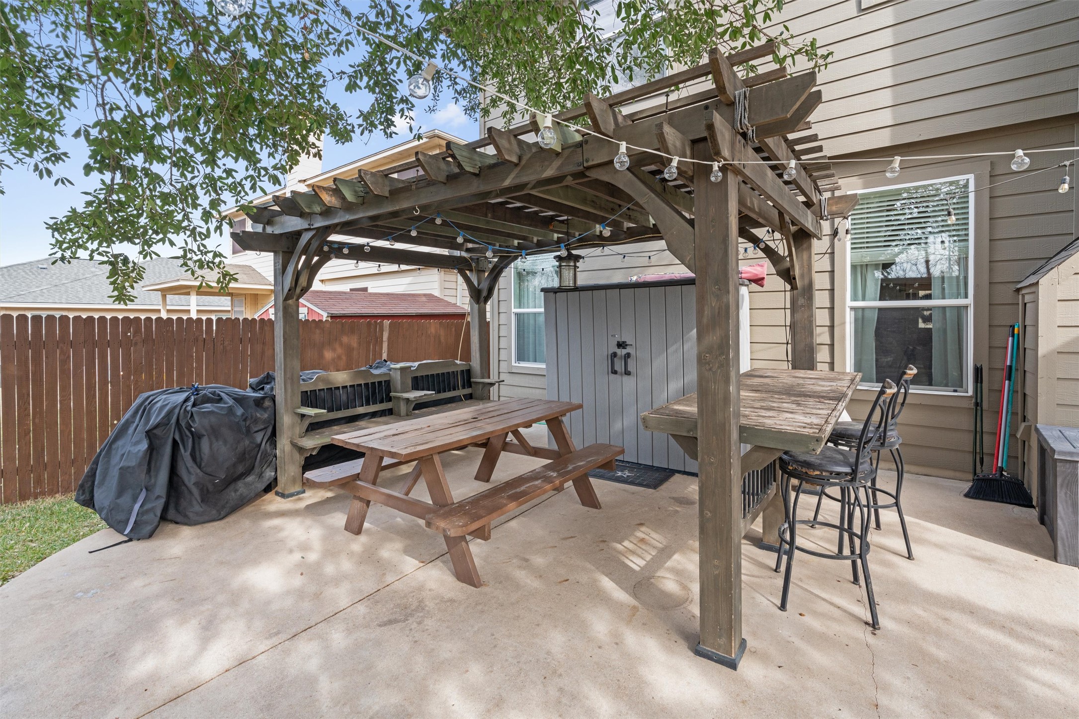 338 Altamont Street Hutto, TX 78634 - Photo 31 of 40 Fenced backyard with outdoor dining space, a pergola, a patio, and grilling area