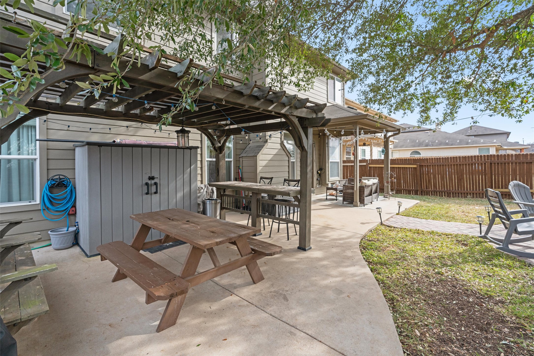 338 Altamont Street Hutto, TX 78634 - Photo 32 of 40 Fenced backyard featuring outdoor dining space, a pergola, and a patio