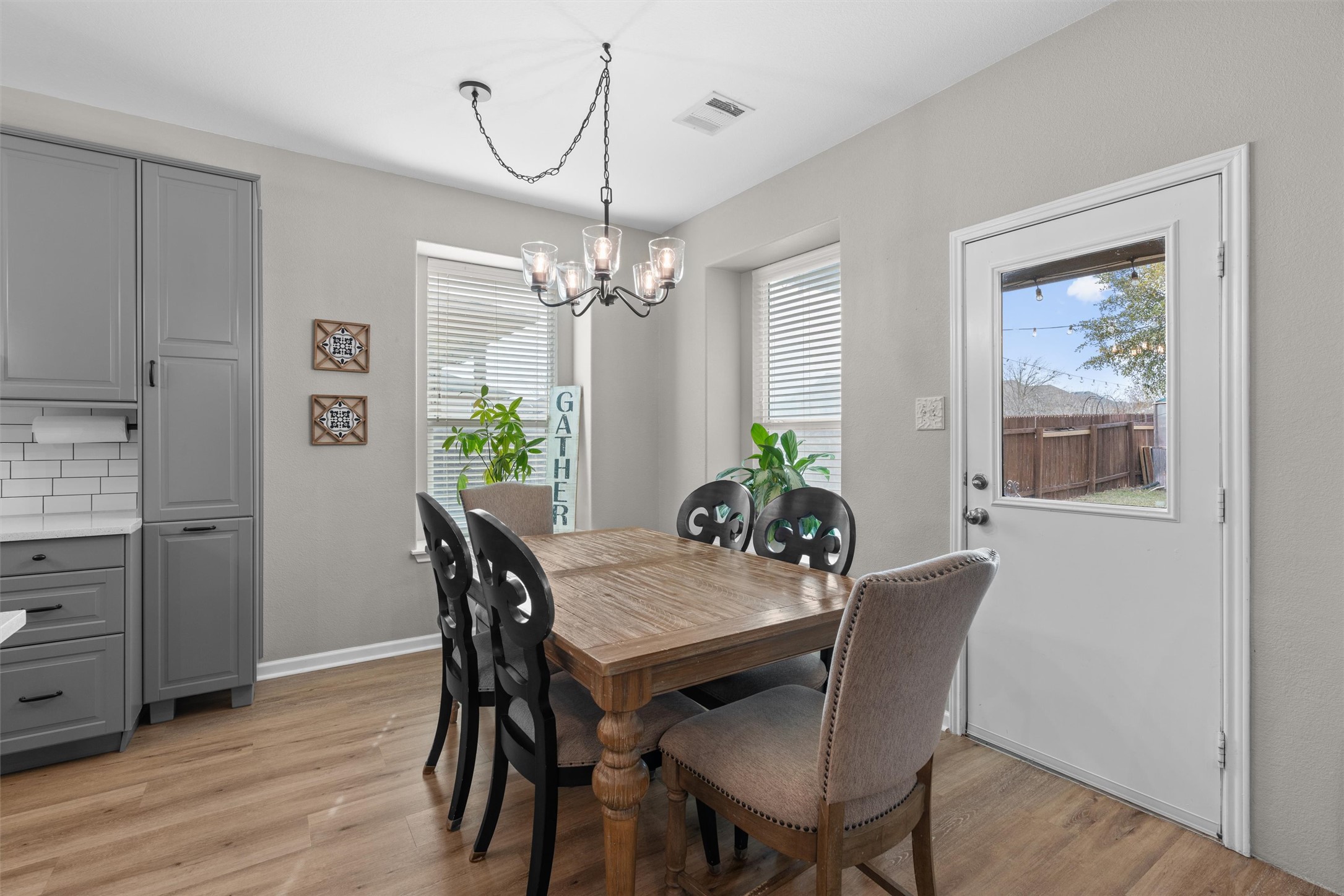 338 Altamont Street Hutto, TX 78634 - Photo 9 of 40 Dining room featuring light wood-type flooring and hanging lights