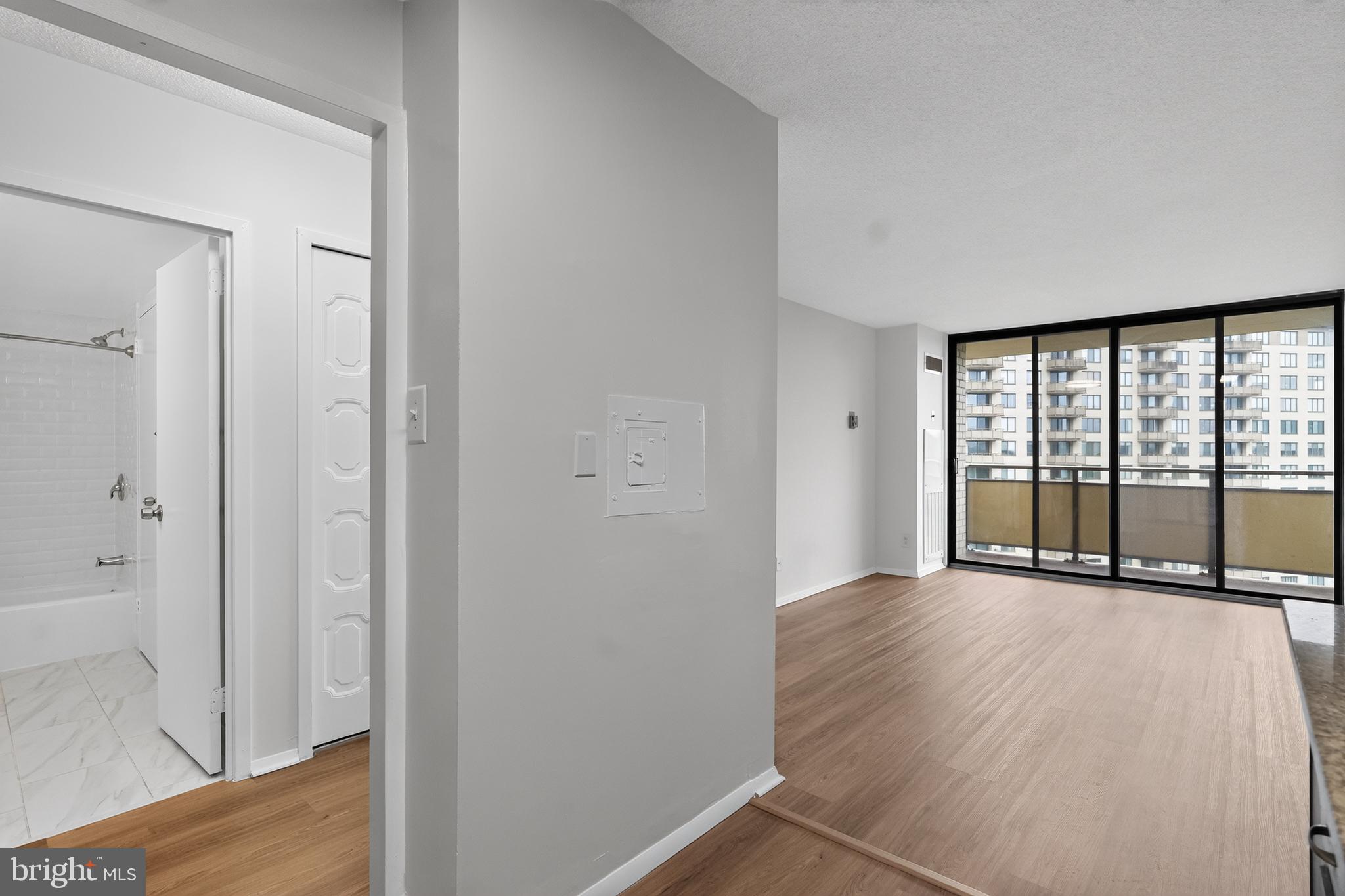 5225 Pooks Hill Road, Unit 1302N Bethesda, MD 20814 - Photo 10 of 19 a view of an empty room with wooden floor and a window