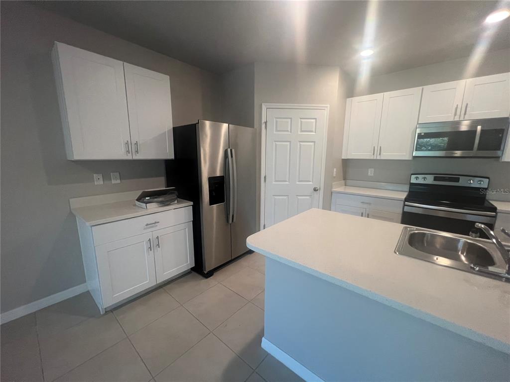 280 Perute Court Punta Gorda, FL 33983 - Photo 19 of 31 a kitchen with a refrigerator and a sink