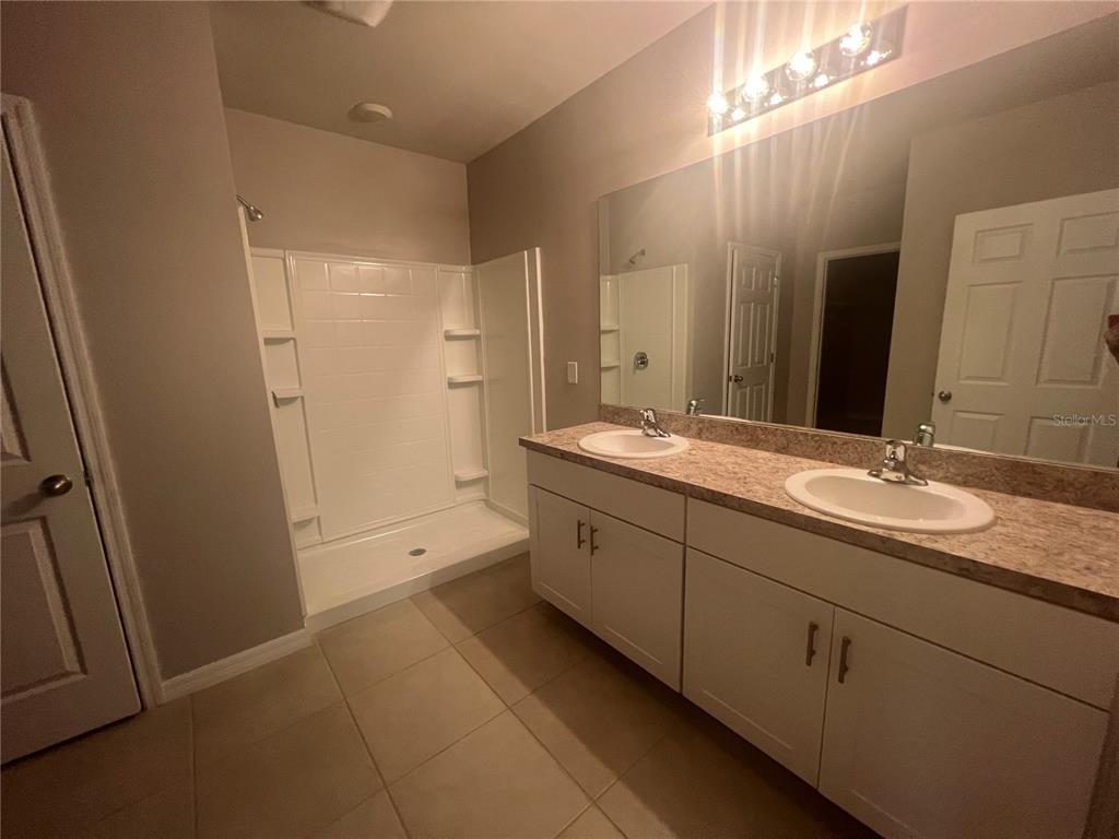 280 Perute Court Punta Gorda, FL 33983 - Photo 26 of 31 a bathroom with double sink and a mirror