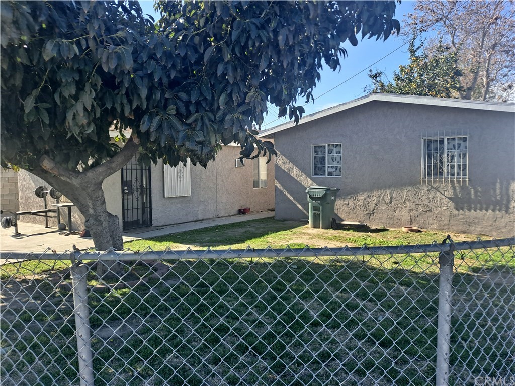 a backyard of house with a large tree