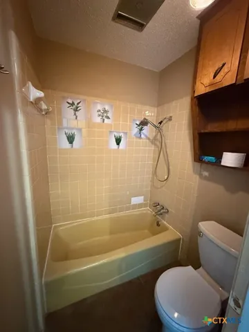 a bathroom with a toilet and shower