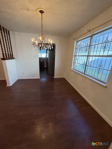 a view of a room with windows and chandelier