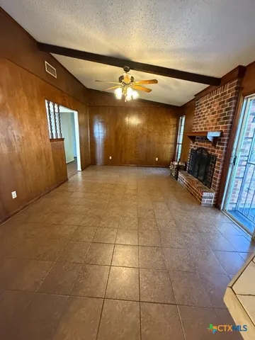 a view of a livingroom with furniture and chandelier fan