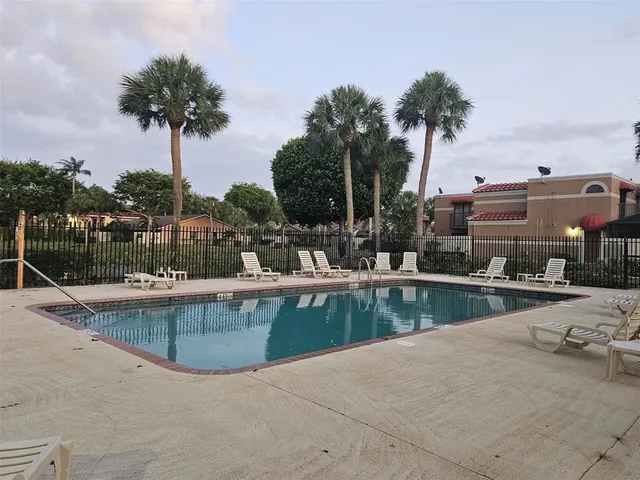 a view of a swimming pool with a table and chairs