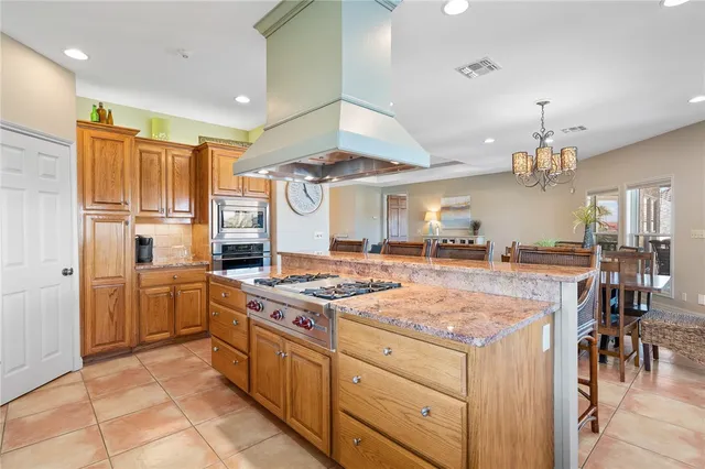a kitchen with a stove a refrigerator and a dining table