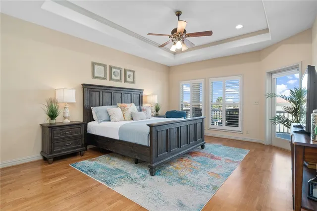 a bedroom with a bed chandelier and a window