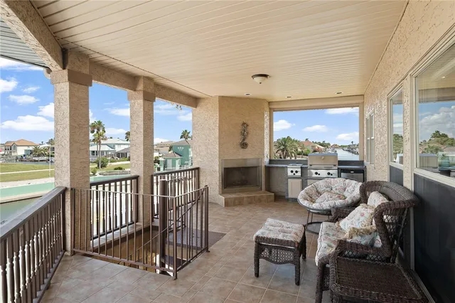 a view of a porch with furniture and floor to ceiling window