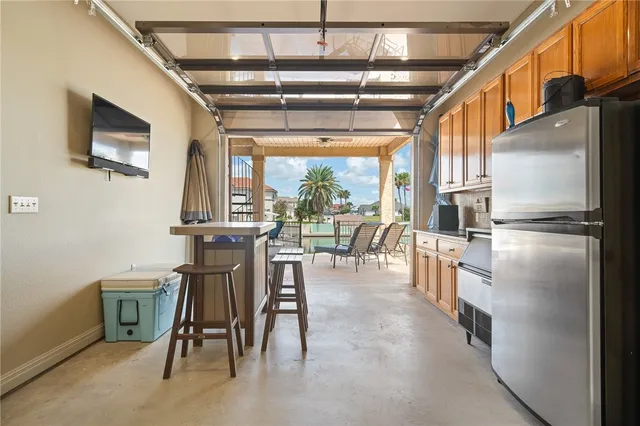 a kitchen with stainless steel appliances granite countertop a refrigerator and microwave
