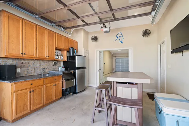 a kitchen with a sink stove and refrigerator
