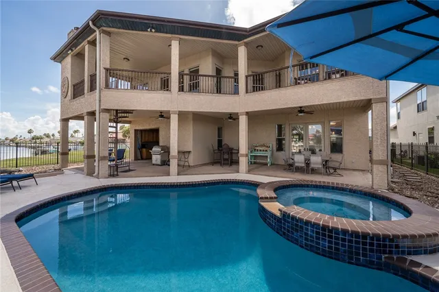 a view of house with swimming pool outdoor seating
