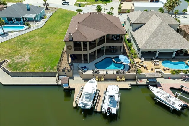 a aerial view of a house with swimming pool and furniture