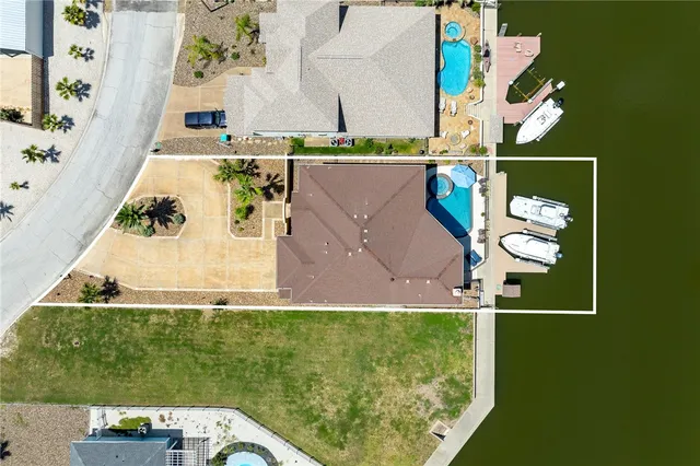 an aerial view of a house with a yard