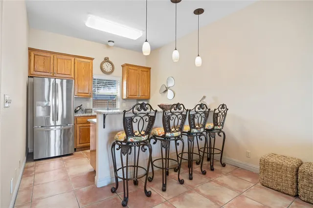 a view of a kitchen with furniture and stainless steel appliances
