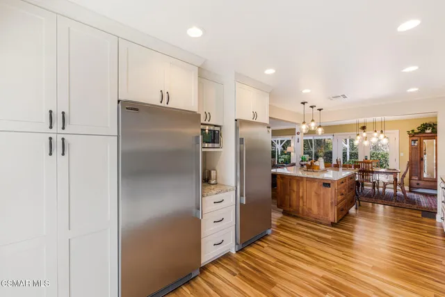 a kitchen with stainless steel appliances granite countertop a stove sink and cabinets