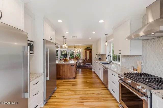 a kitchen with granite countertop a sink cabinets and window