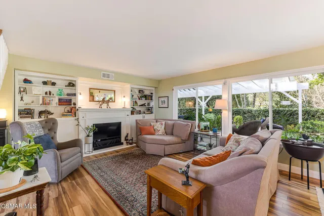 a living room with furniture and stairs