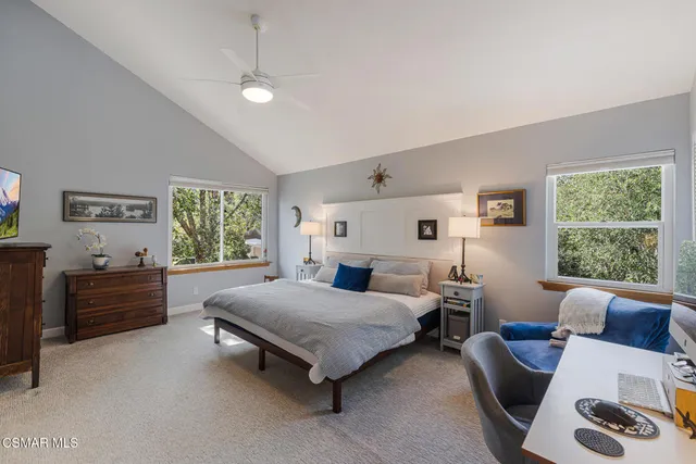 a bedroom with a bed dresser and a large mirror