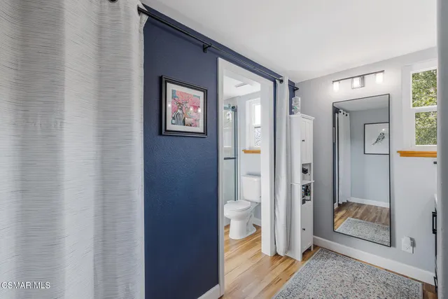 a bedroom with furniture and a window