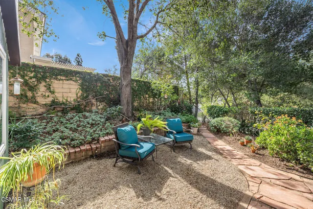 a backyard of a house with outdoor seating and green space