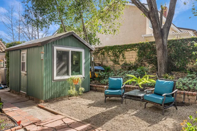 an aerial view of a house with backyard space and balcony