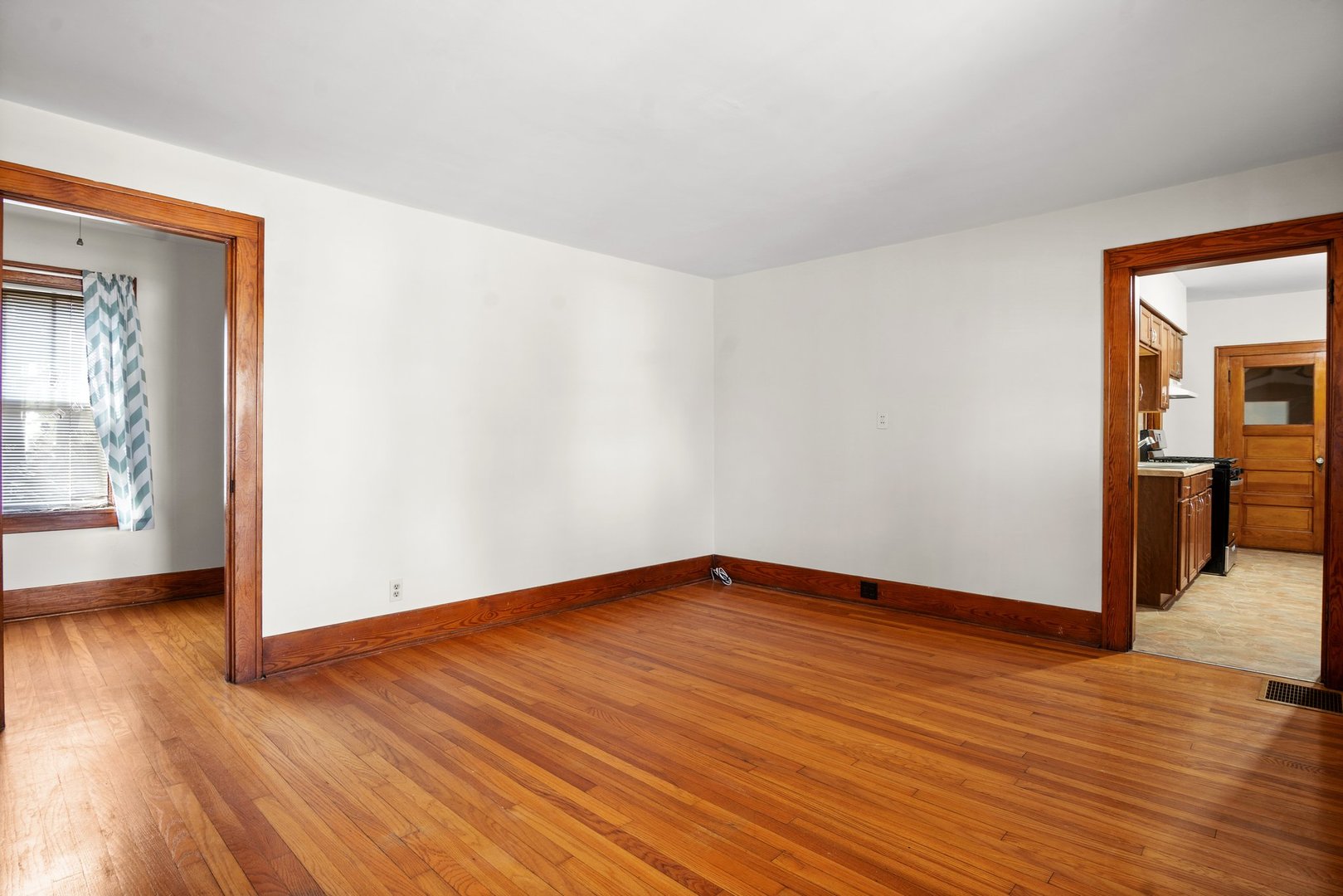 803 South 3rd Street, Unit 1 St. Charles, IL 60174 - Photo 4 of 16 a view of an empty room with wooden floor and a window