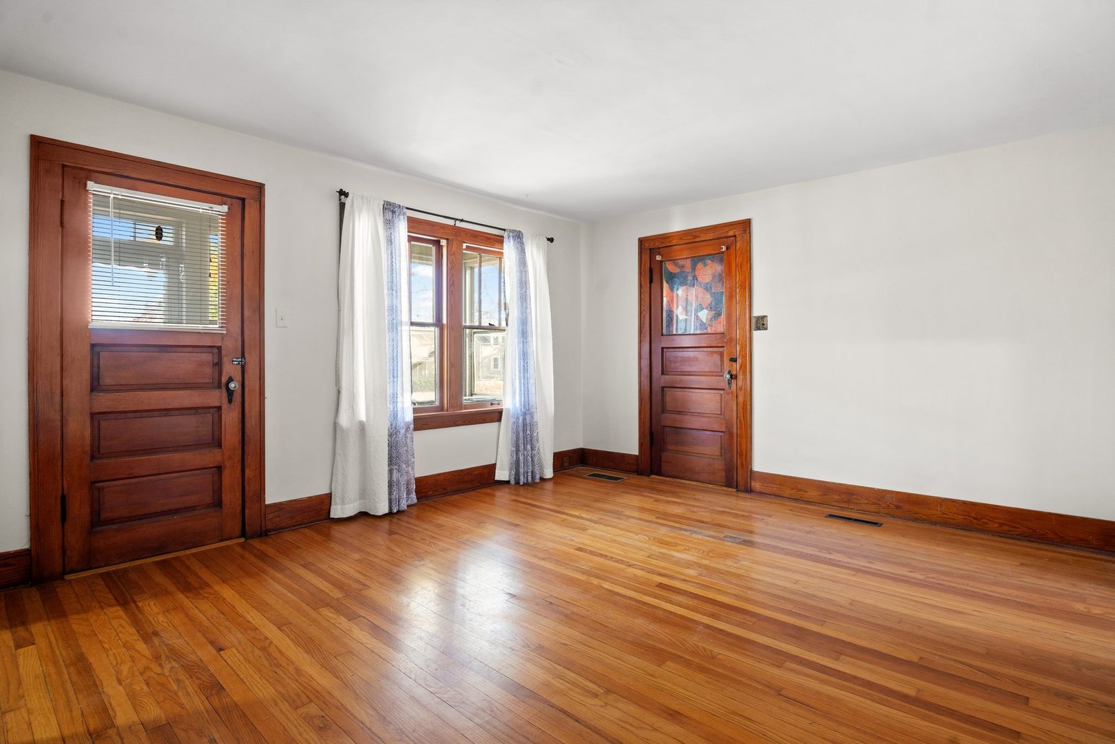 803 South 3rd Street, Unit 1 St. Charles, IL 60174 - Photo 5 of 16 an empty room with wooden floor closet and windows