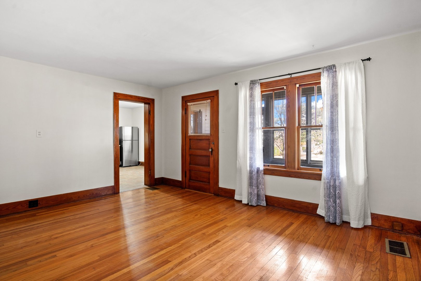 803 South 3rd Street, Unit 1 St. Charles, IL 60174 - Photo 6 of 16 an empty room with wooden floor and windows