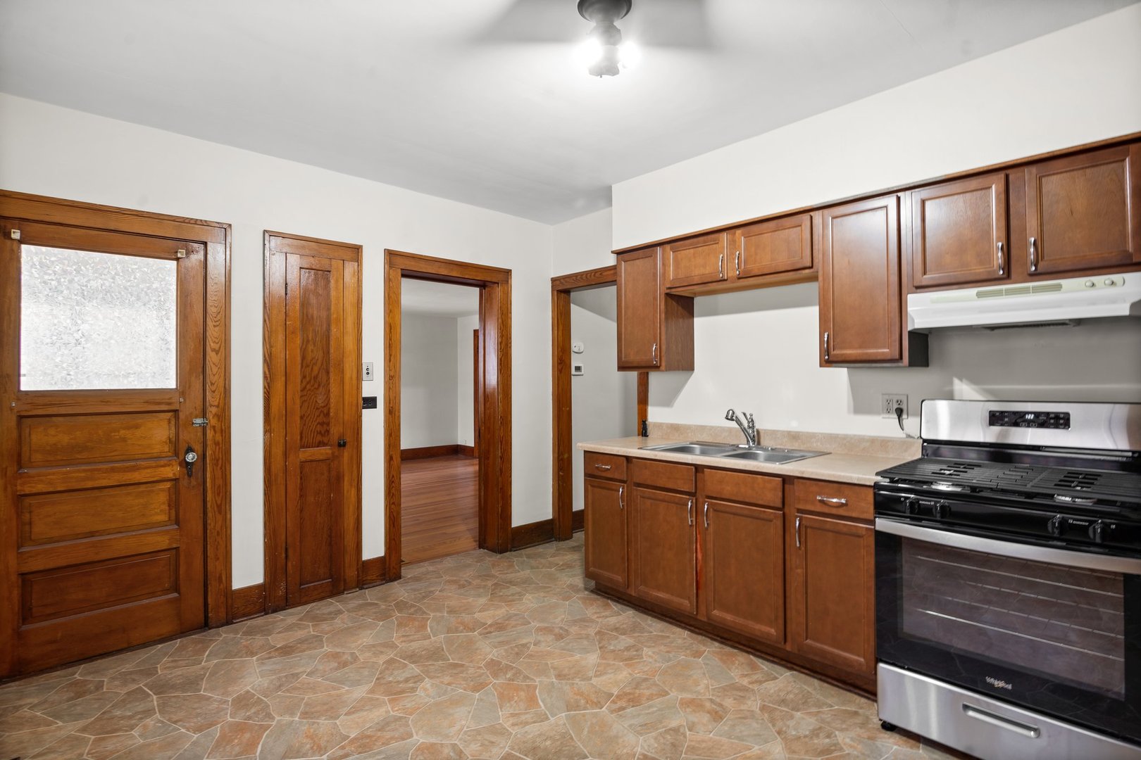 803 South 3rd Street, Unit 1 St. Charles, IL 60174 - Photo 9 of 16 a kitchen with stainless steel appliances granite countertop a stove and a refrigerator