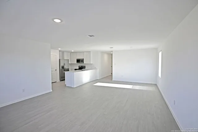 a view of a kitchen with a sink and a refrigerator