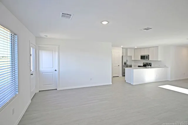 a view of kitchen with white cabinets and white appliances