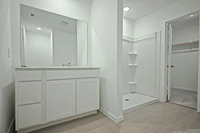 a bathroom with a shower and a sink