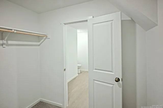 a view of an empty walk in closet