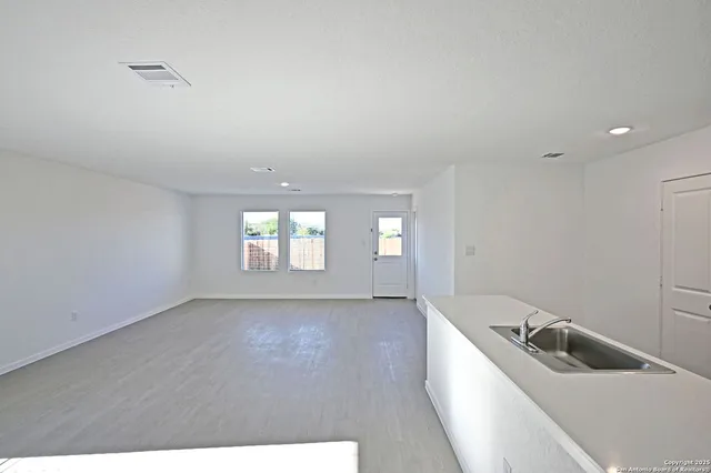 a room with a white tub sitting next to a window