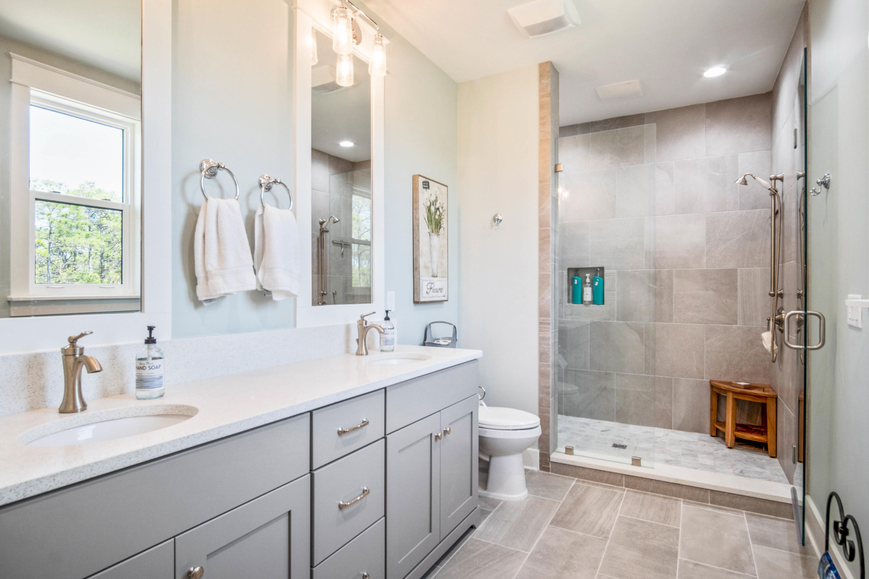 265 Ridgewalk Circle Santa Rosa Beach, FL 32459 - Photo 31 of 62 a spacious bathroom with a double vanity sink toilet mirror and shower